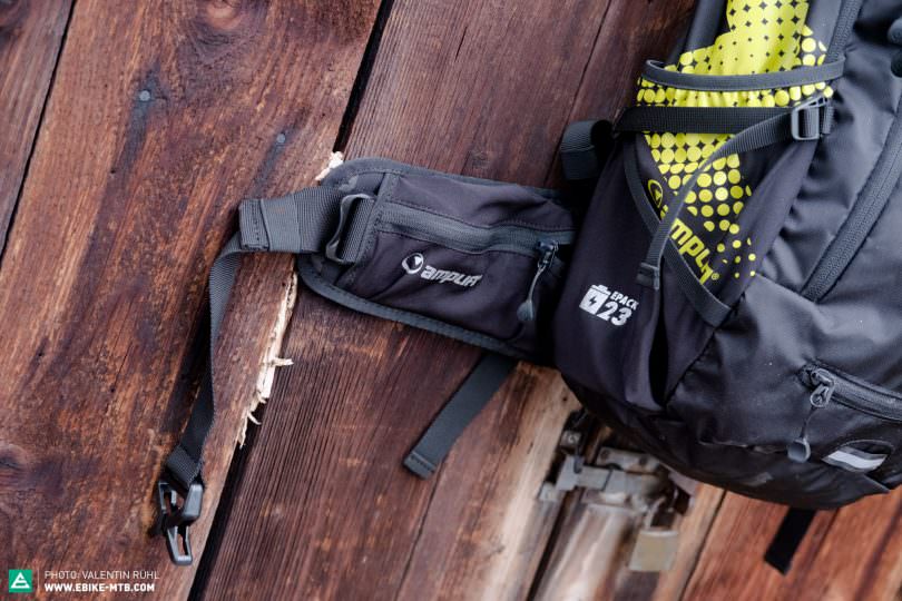The hip belt also has two additional side pockets. There’s a reflective neon rain cover stowed away at the bottom of the backpack.