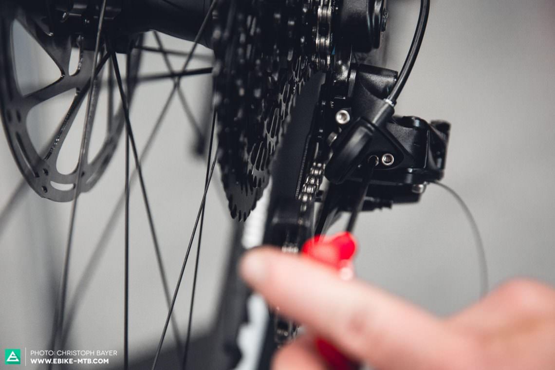 Adjust the outer stop with help of the inside screw on the rear mech. Turn the screw clockwise, and the derailleur moves inwards (i.e., limiting its outward movement) and vice-versa.